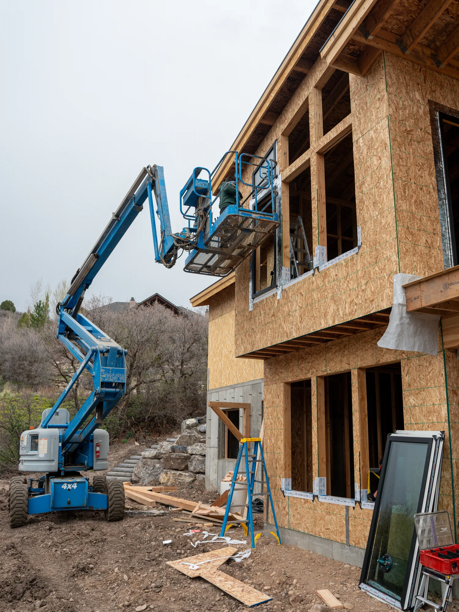 UOME crew placing upper-level windows from an elevated work platform
