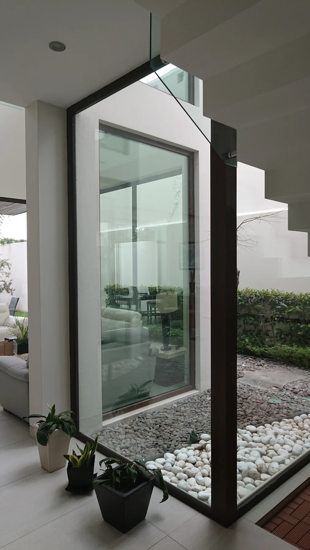 Floor-to-ceiling glass connecting an interior to the outdoors