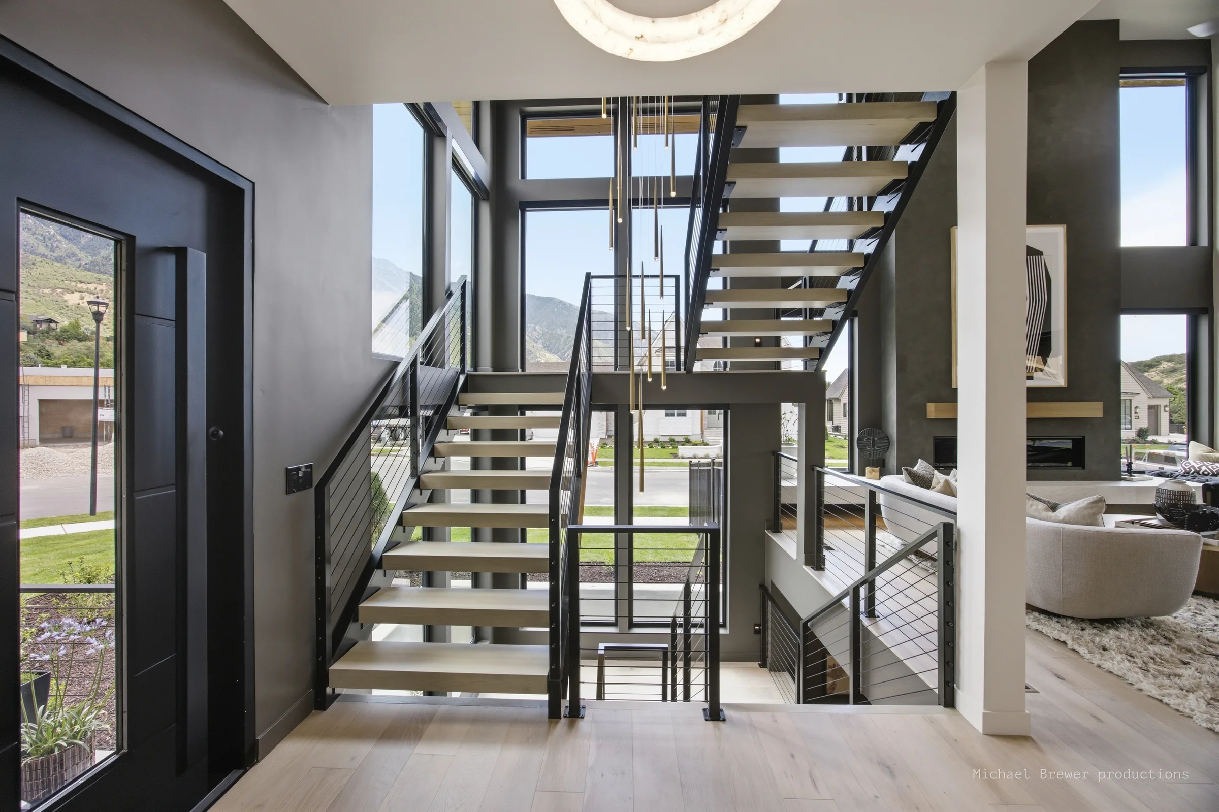 Full-height window wall beside an open staircase