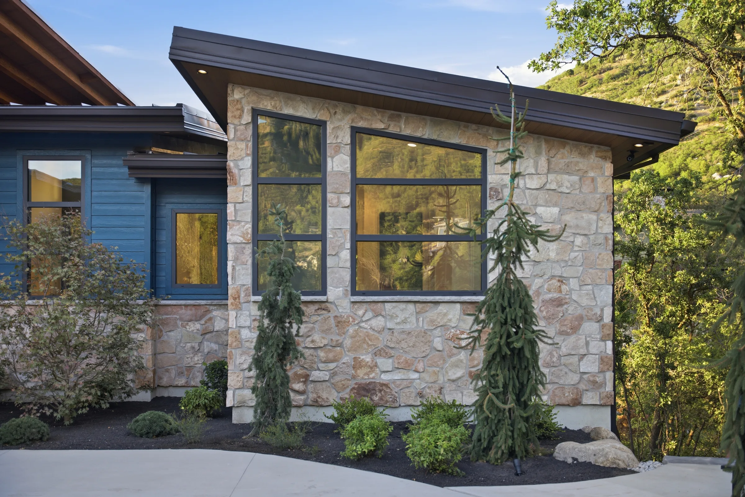Dark-framed windows set into a stone exterior wall